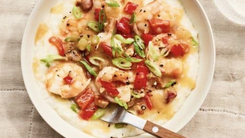 picture of dish of shrimp and grits with fork